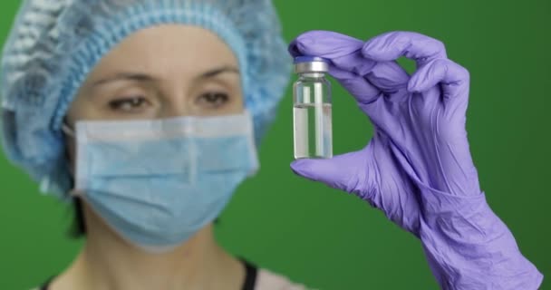 Female scientist holding ampoule in hand, new medication developing, vaccination - 映像、動画