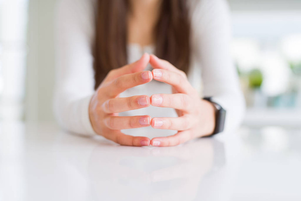 Close up of woman hands over white table - Foto, imagen