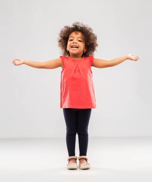 happy little african american girl with arms apart - Fotó, kép