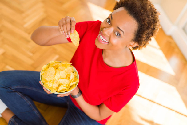 junge schöne afrikanisch-amerikanische Frau mit Afro-Haaren essen Chi - Foto, Bild