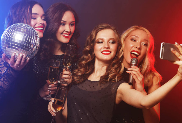 Close-up shot of group of laughing girls having party, take self - Фото, изображение