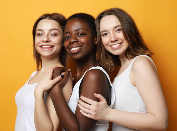 Close-up portrait of three multiracial, african american and european girls. - Фото, изображение