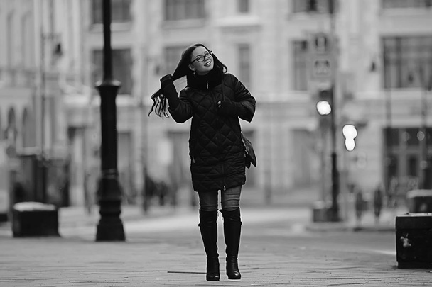 adult model girl in a coat on a winter walk in the city / Christmas vacation city tour - Φωτογραφία, εικόνα