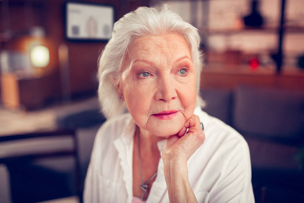 Beautiful blue-eyed aged lady feeling excited and happy - Foto, afbeelding