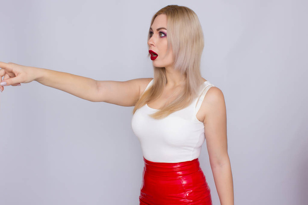 Blonde woman in red leather skirt and white shirt - Foto, Imagen