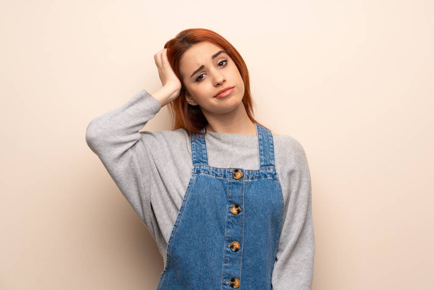 Young redhead woman over isolated background with an expression of frustration and not understanding - Photo, Image