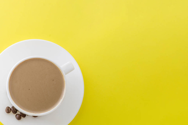 White cup of hot coffee isolated on Yellow background. - Фото, изображение