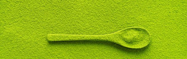 Top view of spoon strewed with green tea Matcha on textured background - Foto, Bild