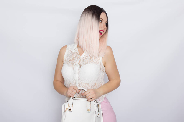 Blonde woman with white handbag - Φωτογραφία, εικόνα