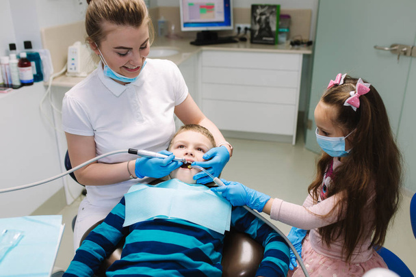 Mała dziewczynka pomocy dentysty, nowe zęby egzaminacjiw leczeniu ubytków - Zdjęcie, obraz