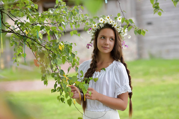 sweet Russian girl girl in a white birch in the summer, with a w - Valokuva, kuva