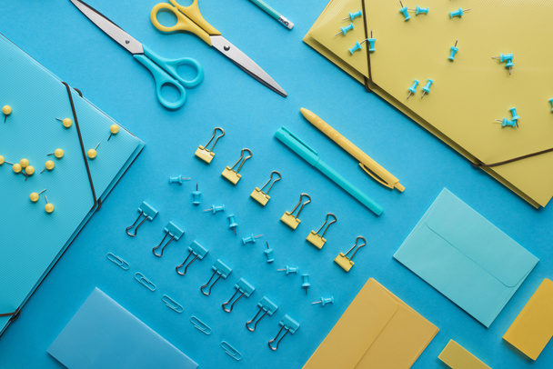 top view of various colorful stationery isolated on blue - Foto, imagen
