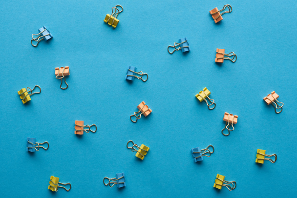 top view of colorful paper clips isolated on blue - Photo, Image