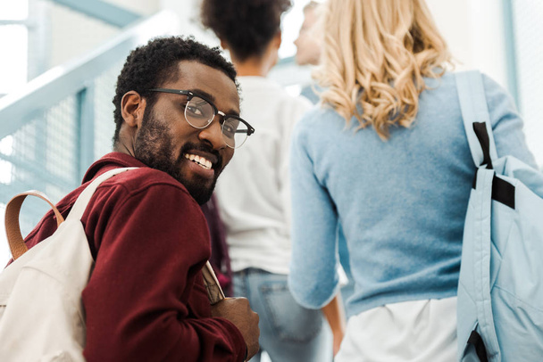 smiling african american student in glasses with backpack looking at camera - Photo, Image