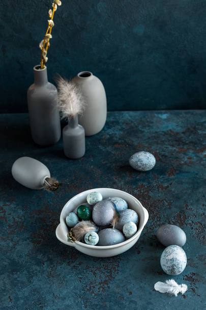 Composition of Easter eggs on a plate on a gray blue textured stone background. Copy space. Top view. - Fotografie, Obrázek