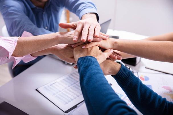 Group Of Businesspeople Stacking Hands Over Desk In Office - Photo, Image