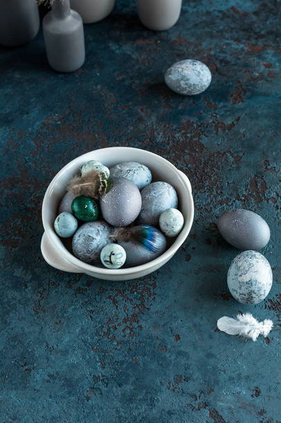 Composition of Easter eggs on a plate on a gray blue textured stone background. Copy space. Top view. - Foto, immagini