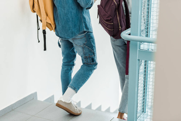cropped view of two students with backpacks in college - Fotoğraf, Görsel