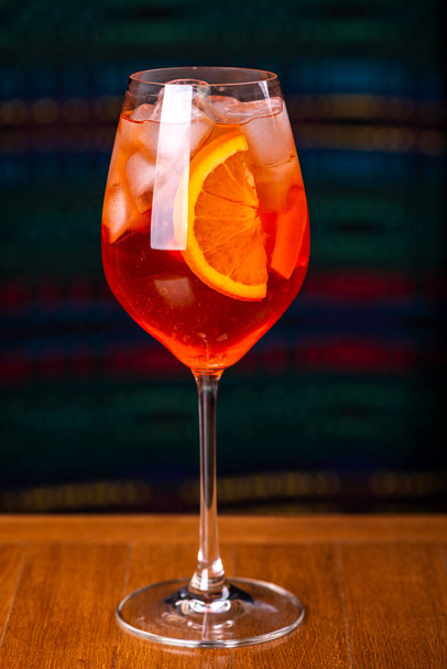 Aperol spritz cocktail in glass on wooden table in the interior of the restaurant. - Fotó, kép