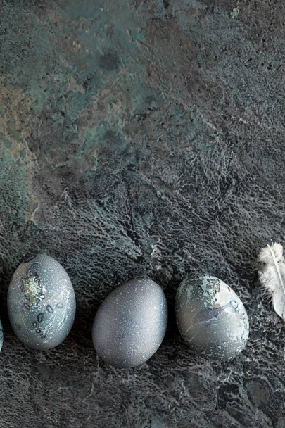 composition with futuristic Easter eggs on a textured stone background. Copy space. Top view. - Valokuva, kuva