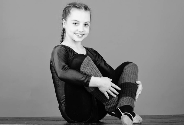 Minute to relax. Girl little gymnast sports leotard. Physical education and gymnastics. Flexible body. Rhythmic gymnastics girlish sport. Rhythmic gymnastics sport combines elements ballet dance - Photo, image