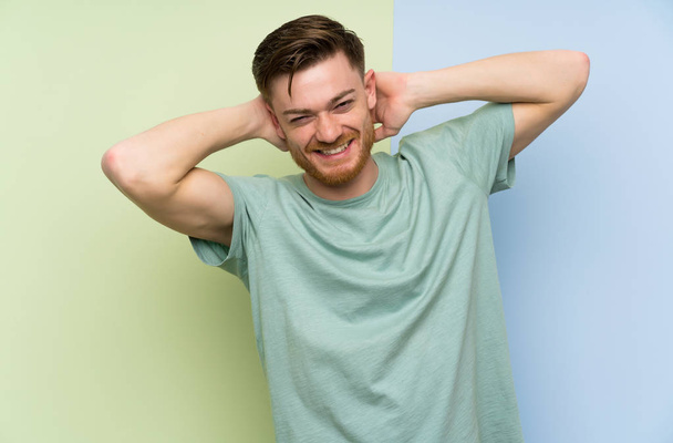 Redhead man over colorful background laughing - Photo, Image