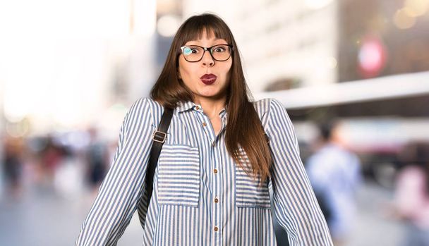 Woman with glasses with surprise facial expression at outdoors - Photo, Image