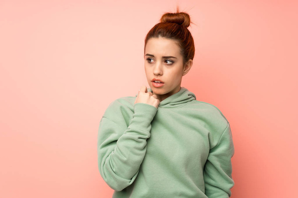 Young redhead woman with sweatshirt with tired and sick expression - Фото, изображение