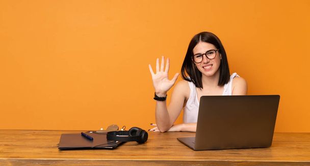 Business woman in a office saluting with hand with happy expression - Fotoğraf, Görsel
