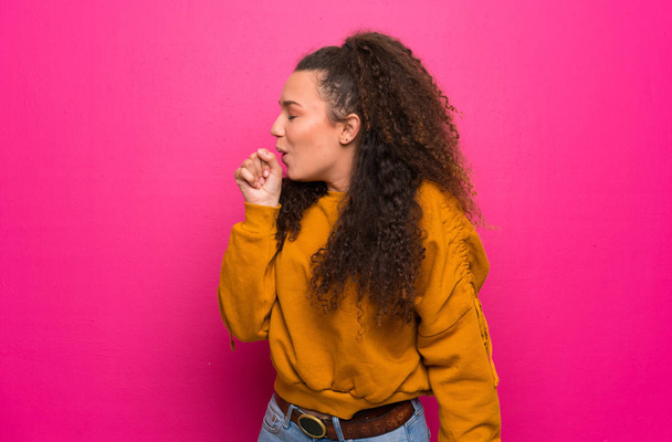 Teenager girl over pink wall is suffering with cough and feeling bad - Zdjęcie, obraz