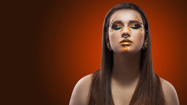 portrait of a girl. luxury shining makeup on the dark background - Photo, image