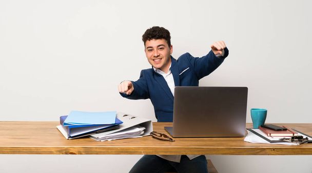 Business man in a office points finger at you while smiling - Photo, image