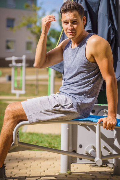 Man using outdoor sport workout machine - 写真・画像