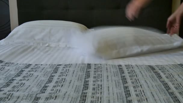 Preparation of hotel room. Person smoothing out pillows for a freshly made bed in a hotel room or fancy home. Hotel service. - Footage, Video
