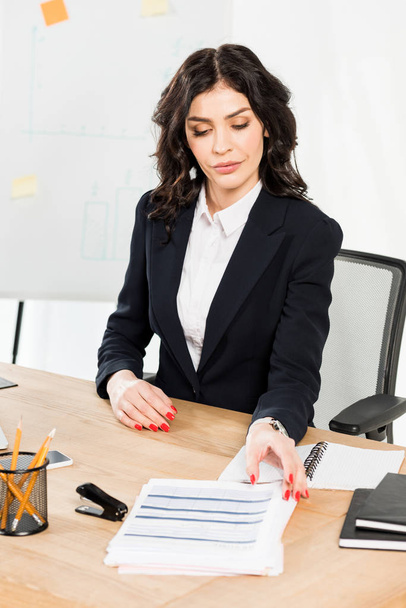 attractive brunette recruiter in formal wear sitting in office  - Photo, image