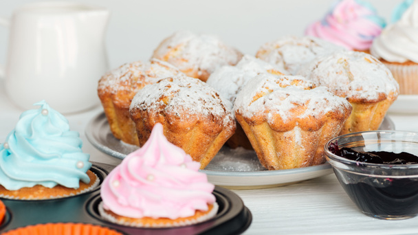 selective focus of muffins decorated with powdered sugar on plate - 写真・画像