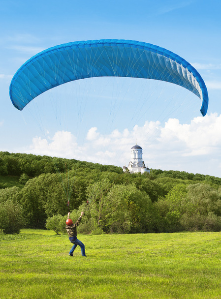 Paraglider. Man with parachute struggling with the wind. In the - Photo, Image