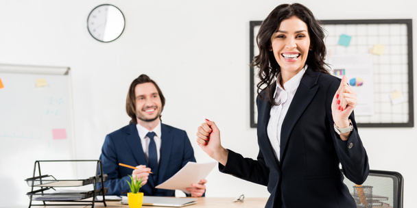 panoramic shot of cheerful woman looking at camera near handsome recruiter  - Photo, image