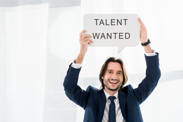 cheerful recruiter holding speech bubble with talent wanted lettering  - Photo, Image