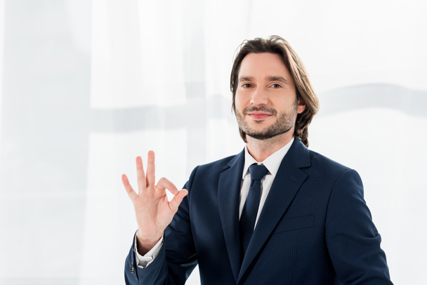 cheerful recruiter showing ok sign and looking at camera  - Photo, image