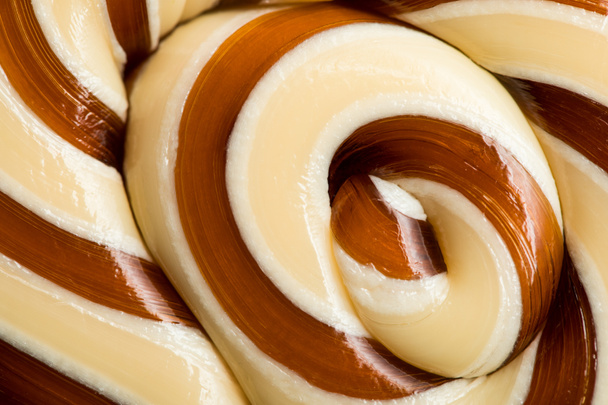 close up view of beige and brown swirl tasty sweet lollipop - Photo, Image