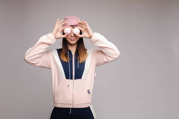 Brunette girl in pink and dark blue costume hiding eyes. - Photo, Image