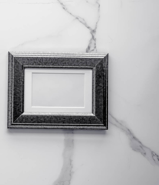 Black photo frame on marble, flatlay - Φωτογραφία, εικόνα