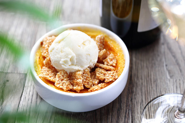 Dessert of cream brulee with ice cream and sesame in caramel. - Photo, Image