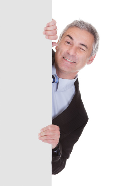 Mature Businessman Pointing At Placard - Foto, immagini