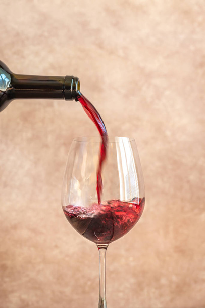 Red wine pouring into glass - Foto, imagen