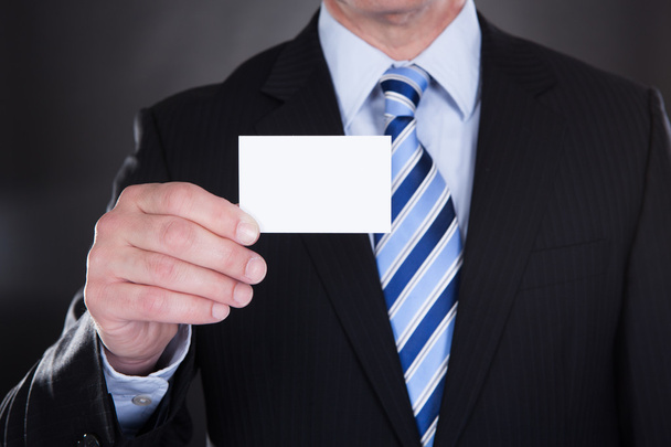 Close-up Of Businessman Holding Visiting Card - 写真・画像
