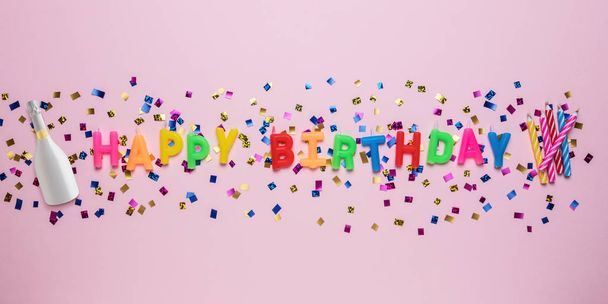 Colorful celebration background with various party confetti and candle decoration. Minimal birthday concept. Flat lay. - Photo, image