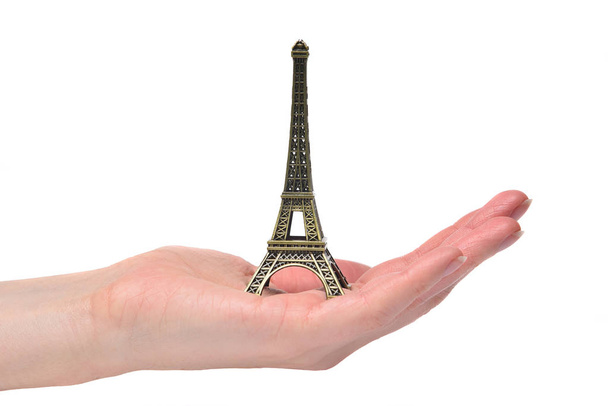 Eiffel Tower - a souvenir, a symbol of France in the hand of a g - 写真・画像