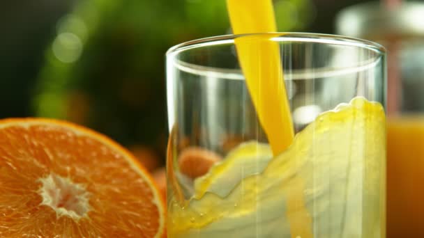 Super slow motion of pouring orange juice into glass. Filmed on high speed cinema camera, 1000 fps. - Кадри, відео